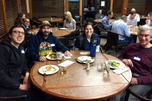 Groups enjoying dinner around tables at the study club