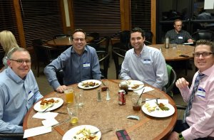 Group enjoying dinner around a table at the study club